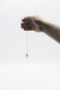 Pendulum dowsing on an isolated white background with a silver point