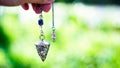 Holding and using quartz crystal pendulum Royalty Free Stock Photo