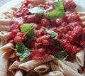 Pene pasta ragu with fresh vine tomatoes and basil Italy chef plate