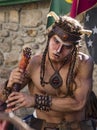 Penedono , Portugal - July 1, 2017 - Man dressed as a satyr gazes with hypnotic inteest at a nearby numph in Medieval