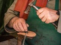 Traditional shoe maker works on heel insert