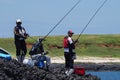 Penghu countyPescadores, Taiwan - A group of people fish on the coastal reef rocks.