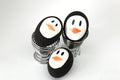 Penguin Easter Eggs on metal egg cup white background Royalty Free Stock Photo