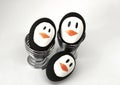 Penguin Easter Eggs on metal egg cup white background Royalty Free Stock Photo