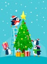 Penguin family decorating christmas tree Royalty Free Stock Photo