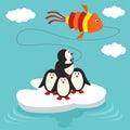 Penguins on ice floe launch a kite in form of fish Royalty Free Stock Photo