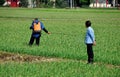 Pengzhou, China: Farmer Spraying Field