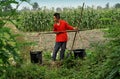 Pengzhou, China: Farmer with Water Buckets Royalty Free Stock Photo