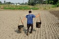 Pengzhou, China: Farmer with Water Pails Royalty Free Stock Photo