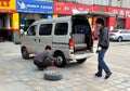 Pengzhou, China: Man Changing Car Tire Royalty Free Stock Photo