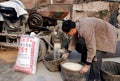Pengzhou, China: Man Husking Rice Grains