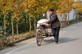 Pengzhou, China: Man Walking Bicycle Cart