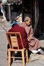 Pengzhou, China: Monk & Woman Sitting in Front of Home Royalty Free Stock Photo