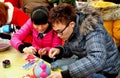 Pengzhou, China: Teenage Couple Painting Figurine Royalty Free Stock Photo