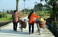 Pengzhou, China: Two Women Walking Bicycles