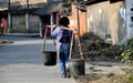 Pengzhou, China: Woman Carrying Water Buckets Royalty Free Stock Photo