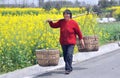 Pengzhou, China: Woman Carrying Wicker Baskets