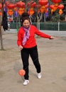 Pengzhou, China: Woman Spinning Ti Huang Top