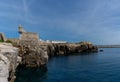 View of the jagged rocky coast and historic fortress in the center of Peniche