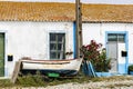 Old fishing boat in front of a Portuguese house Royalty Free Stock Photo