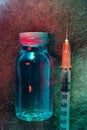penicillin vial and syringe on a multi-colored moldy background