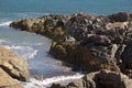 Peninsula of rock jutting out from shore into atlantic ocean