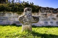 Penitence cross with old medieval abbey wall