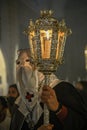 Penitent with a candlestick, in a procession in Holy Week