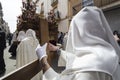 Penitent dressed in white tunic of velvet resting on wooden cro