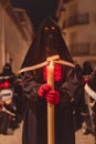 Penitent at night with a lighted candle