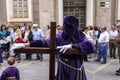 Penitent posed holding his cross during Holy week procession