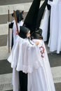 Penitent with small penitent child in her arms in the Easter Week Procession of the Brotherhood of Jesus in his Third Fall on Hol