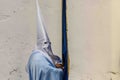 A penitent waiting for the entrance to the temple on Holy Friday