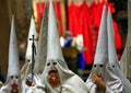 Penitents walk inside church before the start of an easter holy week procession in mallorca detail on hoods