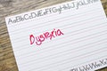 Penmanship Board with the Word Dyslexia Written on it with Red Marker