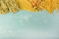 Penne, Mafalde, Tagliatelle, Spaghetti laid out on top of a blue background. Beautiful composition of pasta with space