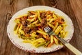 Penne pasta with beef and bolognese sauce and vegetable in plate with fork Royalty Free Stock Photo