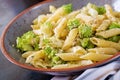 Penne pasta with cabbage romanesco on black table.