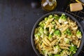 Penne pasta with cabbage romanesco on black table.