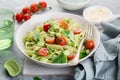 Penne pasta with creamy avocado sauce and tomatoes Royalty Free Stock Photo