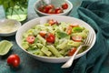 Penne pasta with creamy avocado sauce and tomatoes Royalty Free Stock Photo