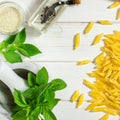 Penne Pasta, green basil, parmesan, sesame, garlic, chilli, eggs lie on a white tree table Royalty Free Stock Photo