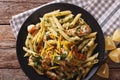 Penne pasta with grilled chicken, greens and lemon sauce close-up. horizontal top view Royalty Free Stock Photo