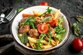 Penne pasta with meatballs and tomato sauce on dark background. banner, menu recipe, top view Royalty Free Stock Photo