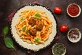 Penne pasta with meatballs in tomato sauce on a dark rustic background. Top view, flat lay, copy space Royalty Free Stock Photo