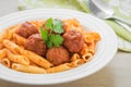 Penne pasta with meatballs in tomato sauce on plate Royalty Free Stock Photo