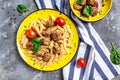 Penne pasta with meatballs and tomato sauce on a yellow plate and a gray background. banner, menu recipe place for text, top view Royalty Free Stock Photo