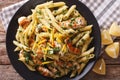 Penne Pasta with pesto, chicken breast and lemon closeup. Horizontal top view Royalty Free Stock Photo