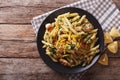 Penne Pasta with pesto, chicken breast and lemon closeup. Horizontal top view Royalty Free Stock Photo