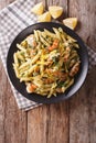 Penne Pasta with pesto, chicken breast and lemon closeup. Vertical top view Royalty Free Stock Photo